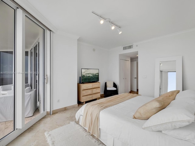 bedroom featuring rail lighting and crown molding