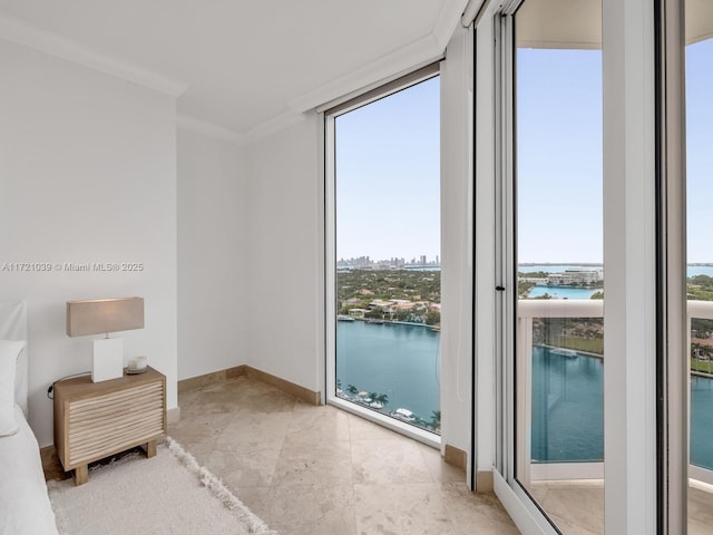 bedroom featuring a water view, a wall of windows, and crown molding