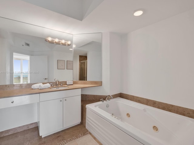 bathroom with plus walk in shower, vanity, and tile patterned flooring