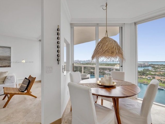 dining room featuring expansive windows, crown molding, and a water view