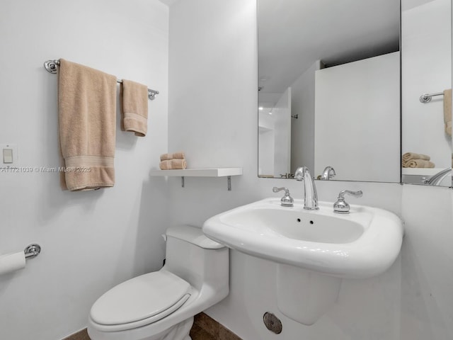 bathroom featuring sink and toilet