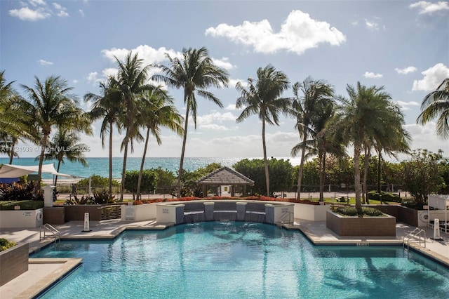 view of swimming pool featuring a water view