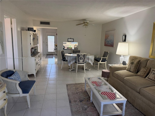 living room with ceiling fan and light tile patterned floors