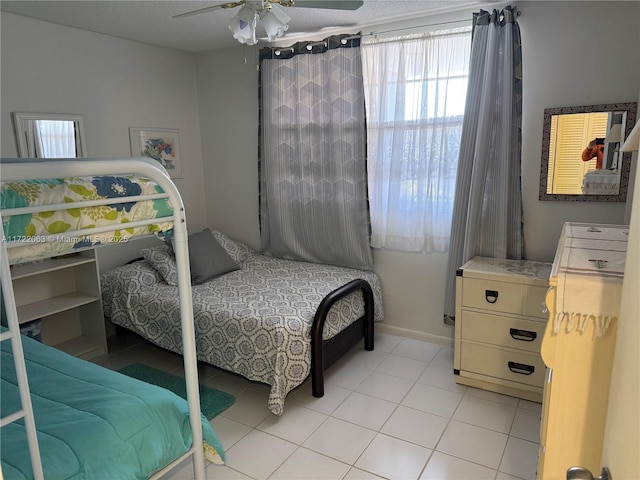 bedroom featuring ceiling fan and light tile patterned flooring