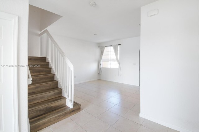 hall featuring light tile patterned floors