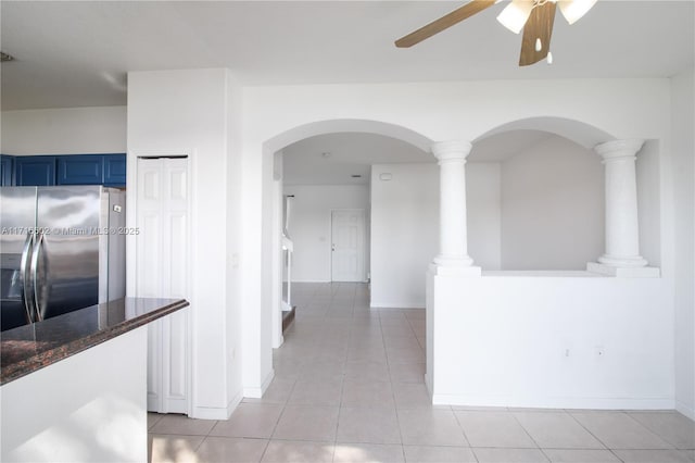 corridor with ornate columns, baseboards, and light tile patterned flooring