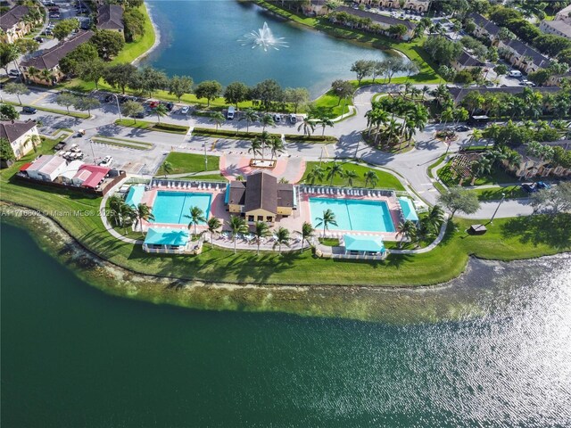 birds eye view of property with a water view