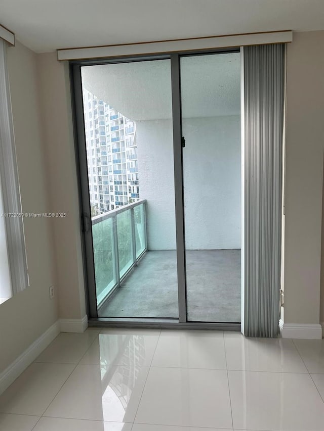 unfurnished room featuring light tile patterned floors