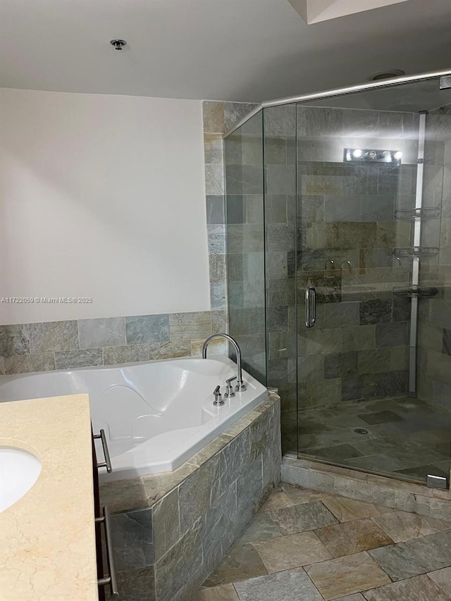 bathroom featuring vanity and separate shower and tub