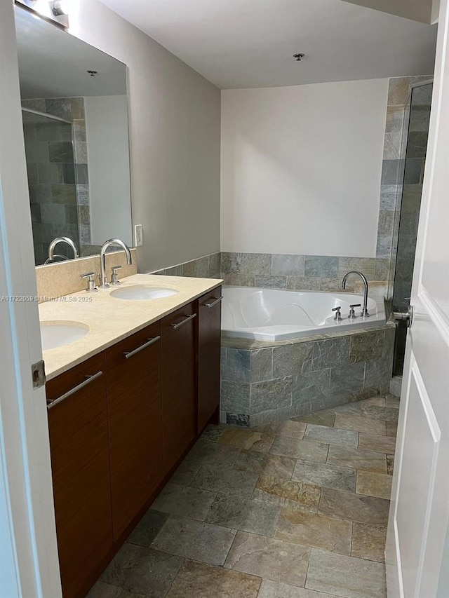 bathroom featuring plus walk in shower and vanity