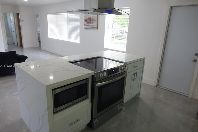 kitchen featuring light stone countertops, stainless steel appliances, island range hood, white cabinets, and a kitchen island