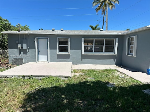 rear view of property with a yard