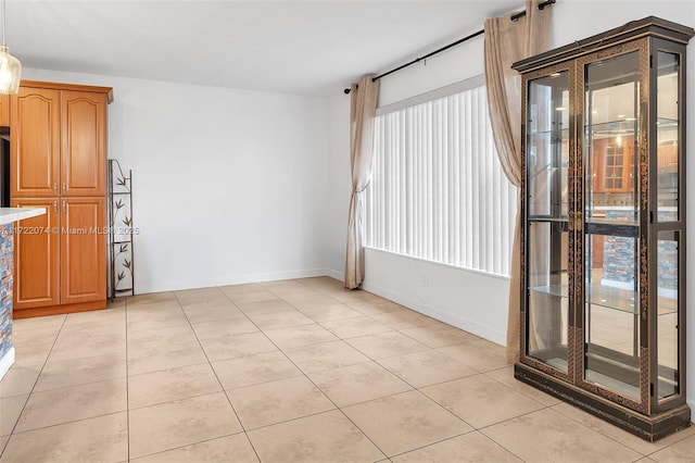 tiled spare room featuring a wealth of natural light