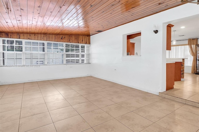 empty room featuring light tile patterned floors and wooden ceiling