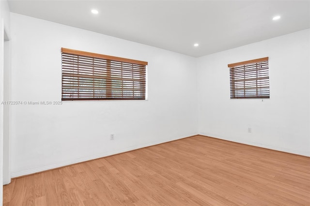 empty room featuring light hardwood / wood-style flooring and a healthy amount of sunlight