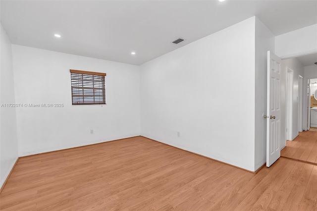 spare room featuring light wood-type flooring