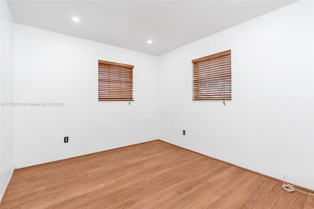 empty room with light hardwood / wood-style flooring