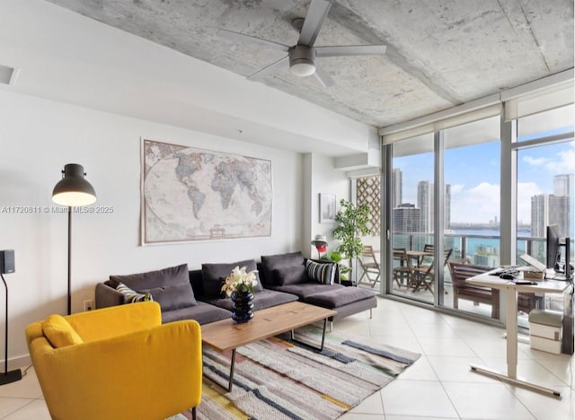 living room featuring ceiling fan and a wall of windows