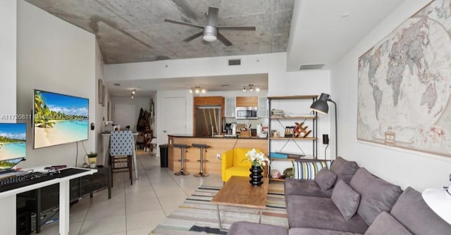 tiled living room with ceiling fan