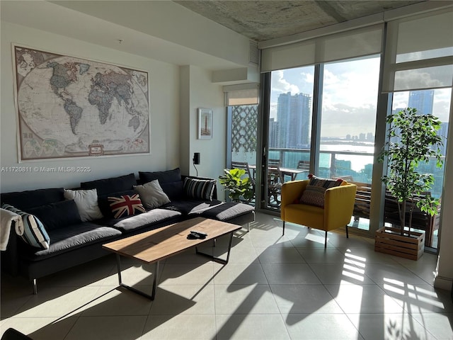 living room featuring expansive windows and light tile patterned flooring