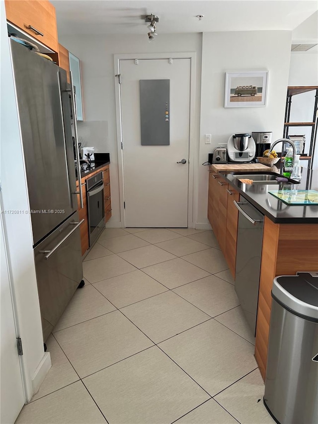 kitchen featuring sink, light tile patterned floors, and appliances with stainless steel finishes