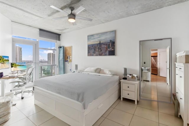 tiled bedroom featuring ceiling fan and stainless steel refrigerator