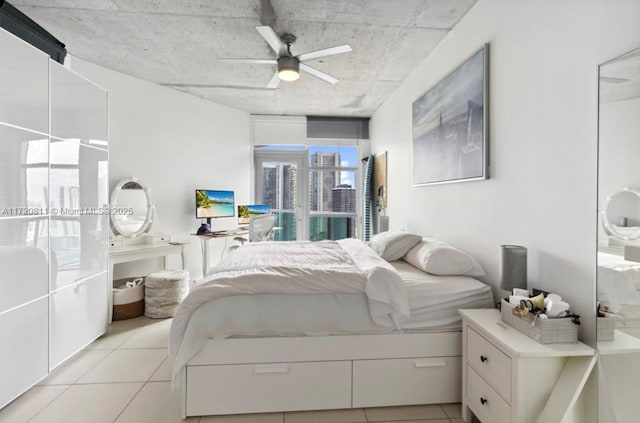 tiled bedroom featuring ceiling fan