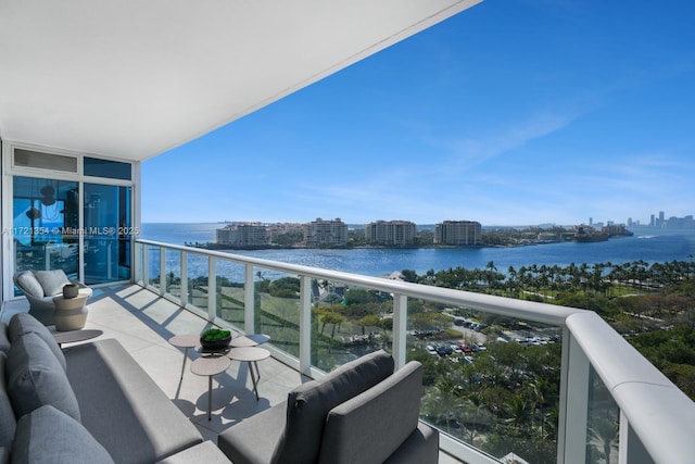 balcony with a water view and a city view