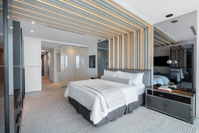 bedroom featuring wallpapered walls, visible vents, and a closet