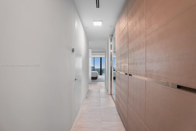 corridor featuring light tile patterned floors