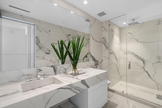 full bathroom with vanity, visible vents, marble finish floor, stone wall, and a marble finish shower