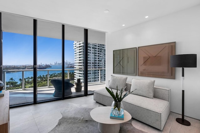 interior space featuring a view of city, a water view, and expansive windows