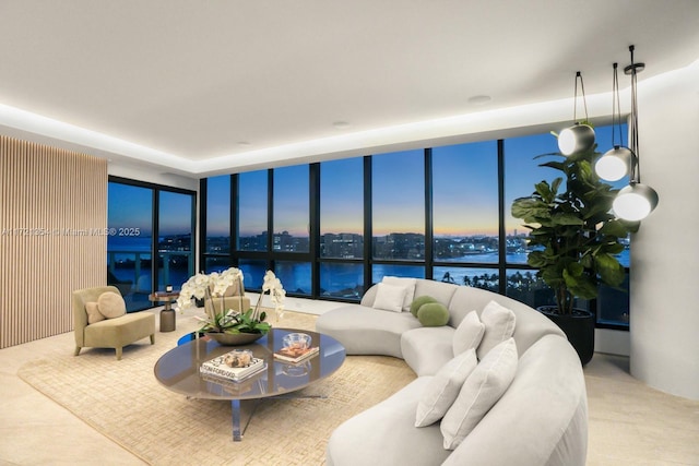 living room with expansive windows and a water view