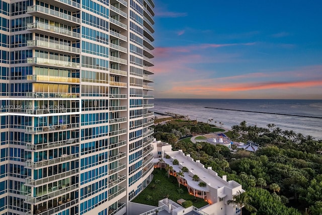 property at dusk featuring a water view