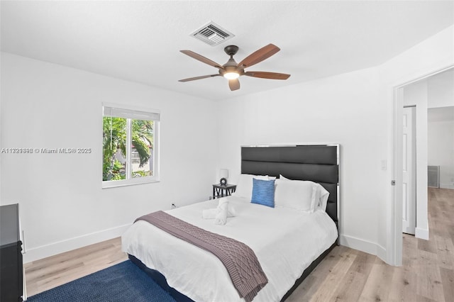 bedroom with light hardwood / wood-style flooring and ceiling fan