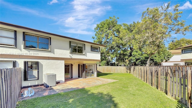 view of yard with central AC and a patio area