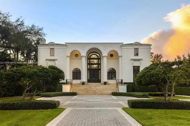 mediterranean / spanish house featuring a lawn