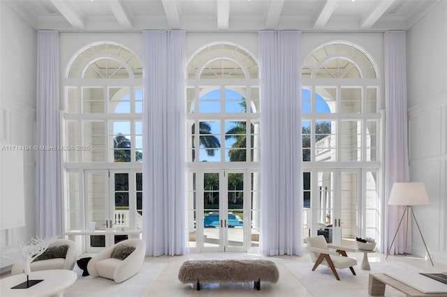 interior space with french doors and beamed ceiling