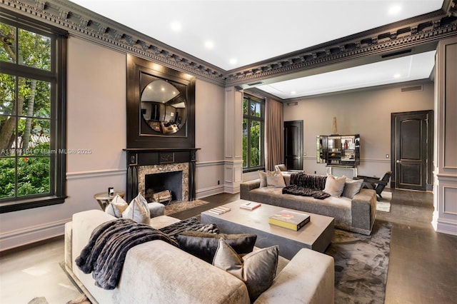 living room with ornamental molding and a premium fireplace