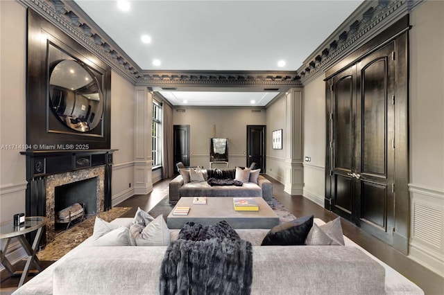 interior space with crown molding, a fireplace, and dark hardwood / wood-style floors