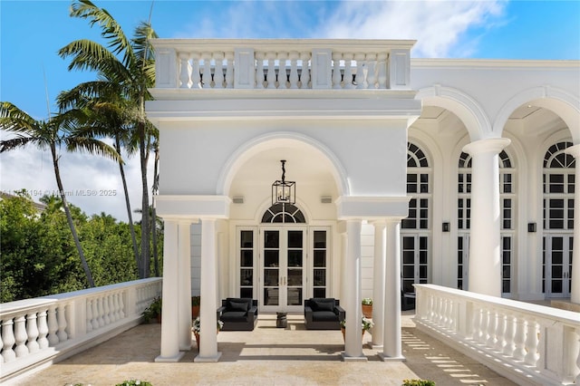 entrance to property featuring french doors and a balcony