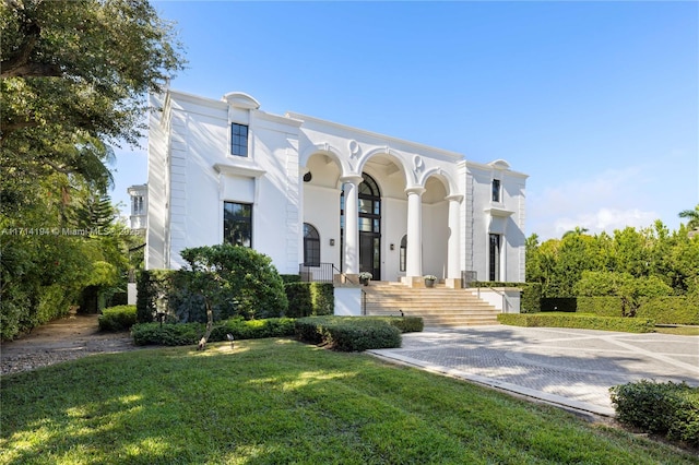 mediterranean / spanish house featuring a front lawn