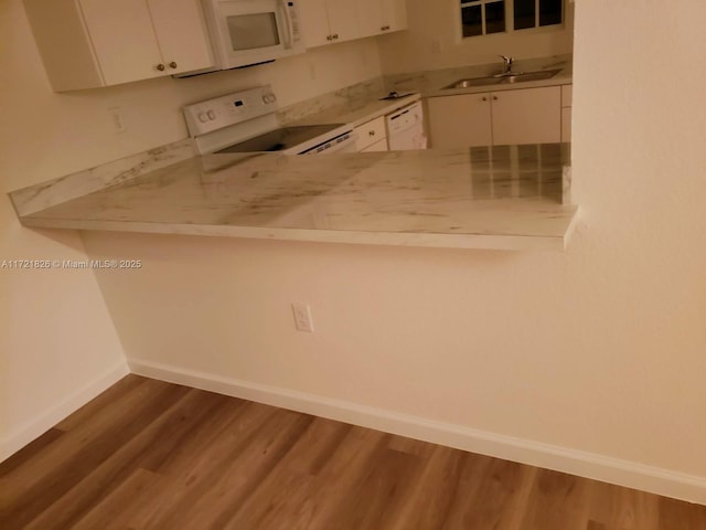 kitchen featuring white cabinets, range, sink, and dark wood-type flooring