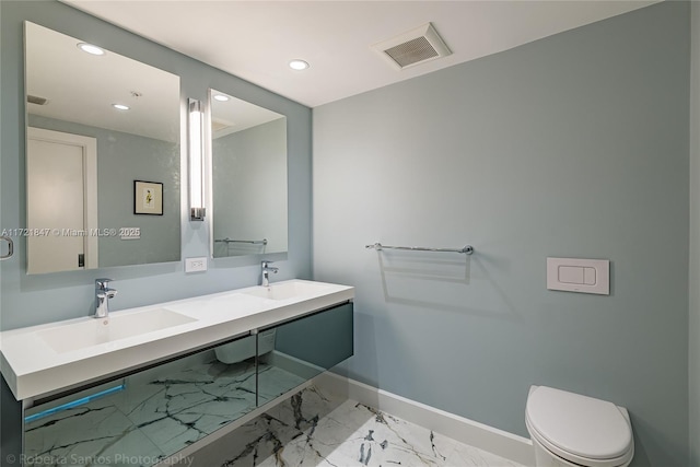 bathroom with vanity and toilet