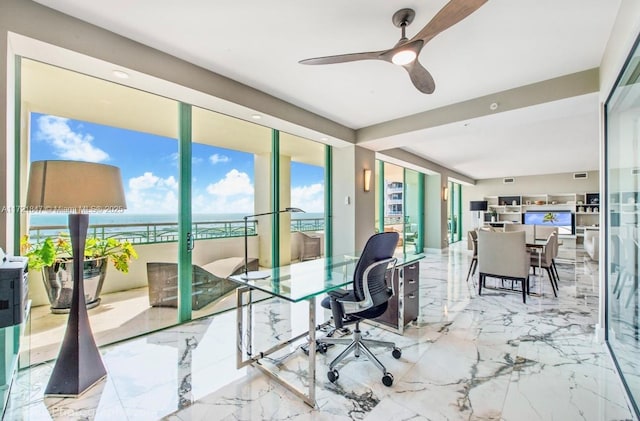 office area with ceiling fan and a water view