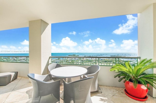 balcony featuring a water view and a view of the beach