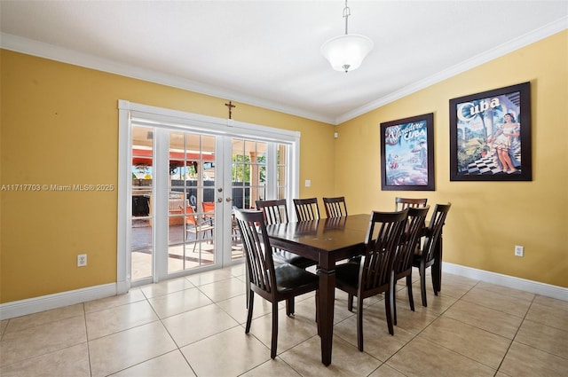 dining space featuring light tile patterned flooring, crown molding, and french doors