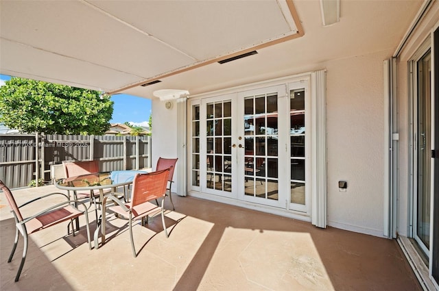 balcony with a patio area and french doors