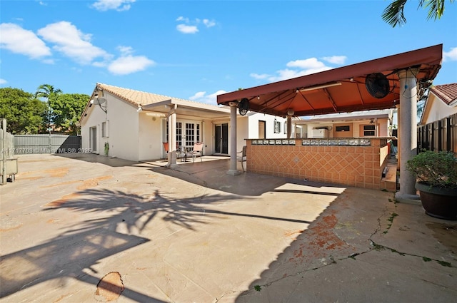 rear view of house with a gazebo and a patio