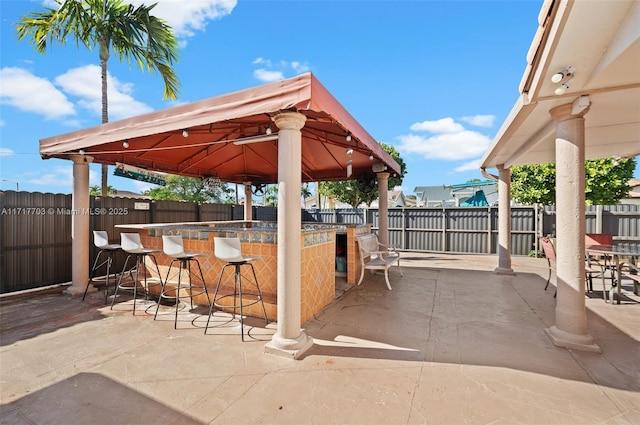 view of patio featuring a gazebo and an outdoor bar